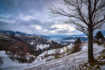 Romanian winter landscape in Carphatians Mountain.The rural winter landscape in the Bran area, Moeciu, Romania