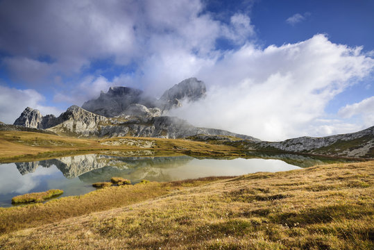 Lake Bodensee surrounded with mountains covered with clouds, Italy
