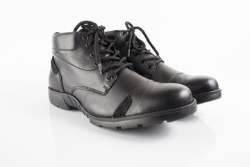 Male black leather boot on white background, isolated product, footwear.