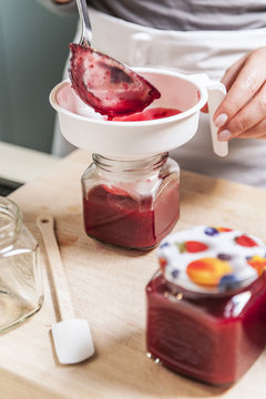 Person filling jam into a glass, Hamburg, Germany