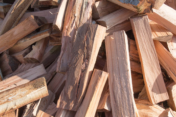 Firewood background - chopped firewood on a stack. Dry chopped firewood logs in a pile