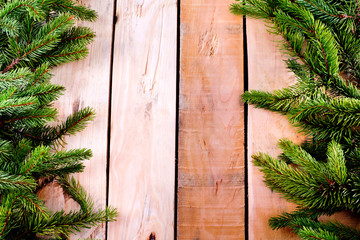 Christmas fir tree frame on natural wooden background.