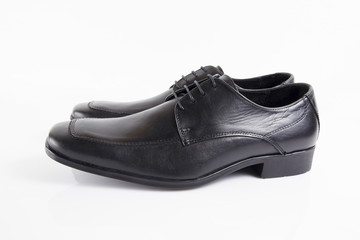 Male black leather shoe on white background, isolated product, footwear.