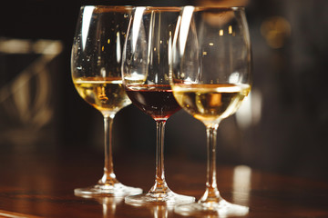 Glasses of white and red wine on bar counter