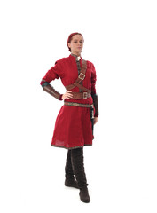 portrait of a red haired girl wearing medieval warrior outfit, studio background.