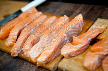 Salmon slices fried in a frying pan in sauce