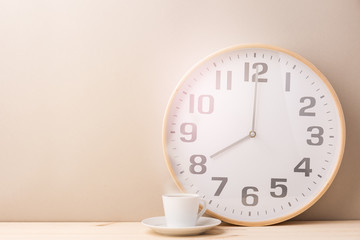 Fototapeta na wymiar Steaming coffee cup and clock