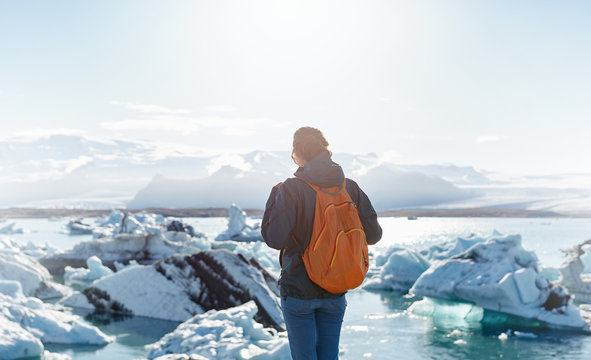 Woman with backpack in Ice Lagoon in Iceland