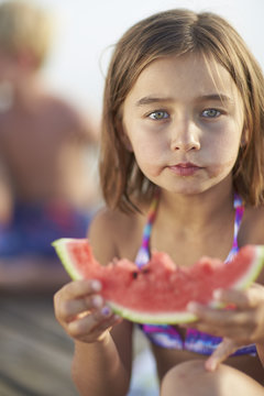 Girl holding a slice of melon, lake Starnberg, Upper Bavaria, Bavaria, Germany