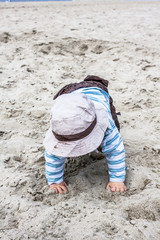 Young toddler playing on the beach