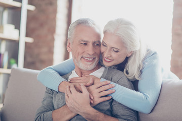 Close up photo of happy joyful beautiful couple of old people who give to each other so warm hugs