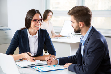 Businesspeople discuss a new project