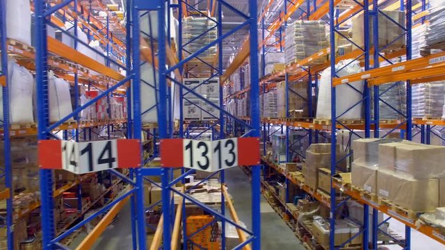 Several half-full warehouse rack rows in a front view. 