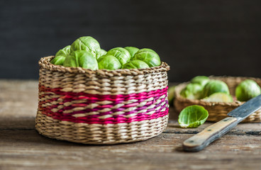 Many Fresh Green Brussels Sprouts in a Basket