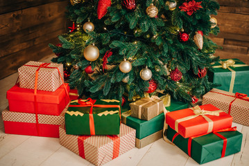 Fototapeta na wymiar Gifts in red, green and beige packaging