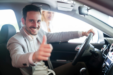 Portrait of happy customer buying new car