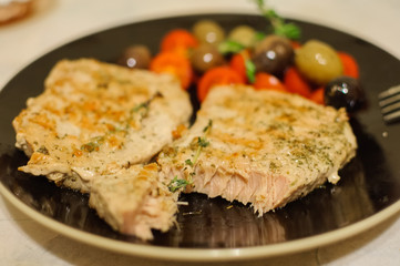 Roasted salmon steak with vegetables on plate