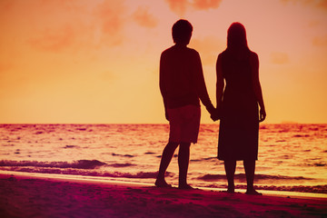 Romantic couple on the beach at sunset