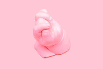 Pink ceramic plaster cast of a hand, art sculpture in pink
