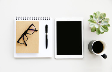 Office table with glasses,notebook,Coffee,pen and cactus, copy space,Top view, flat lay