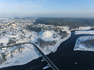 Aerial view over river Nemunas and Merkys connection in small town Merkine, Lithuania. Aerial photography during winter season.