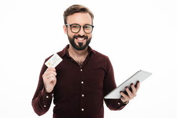 Portrait of a smiling happy man holding tablet computer