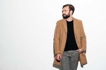 Fototapeta premium Portrait of a stylish bearded man dressed in a coat