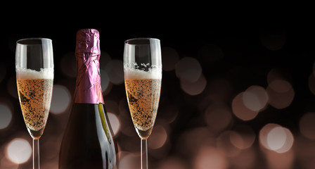 Bottle and two glasses with champagne. New Year Celebration.