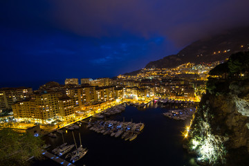 Fototapeta na wymiar Panoramic view of Port de Fontvieille at night in Monaco. Azur coast. Luxury yachts