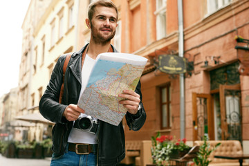 Man Tourist With Map Walking On Street, Traveling