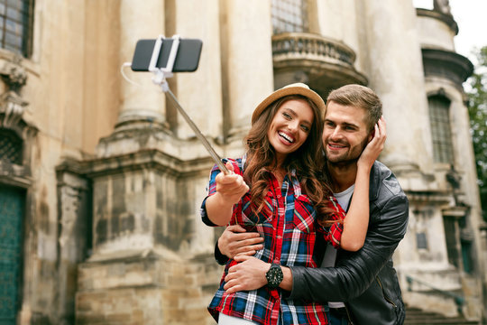 Lovely Tourist Couple Taking Photos On Phone On Street