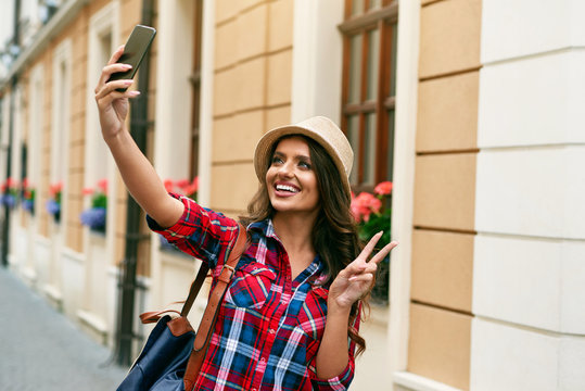 Beautiful Tourist Woman Taking Photos On Phone Outdoors.