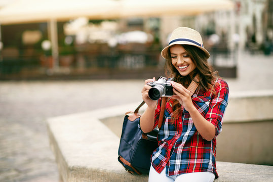 Beautiful Tourist Girl With Camera In Hands.