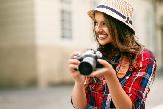 Beautiful Tourist Girl With Camera In Hands.