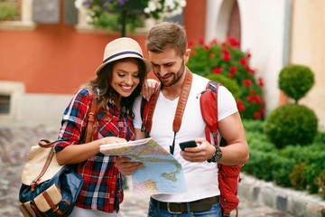 Young Tourist Couple Looking For Attractions On Map.