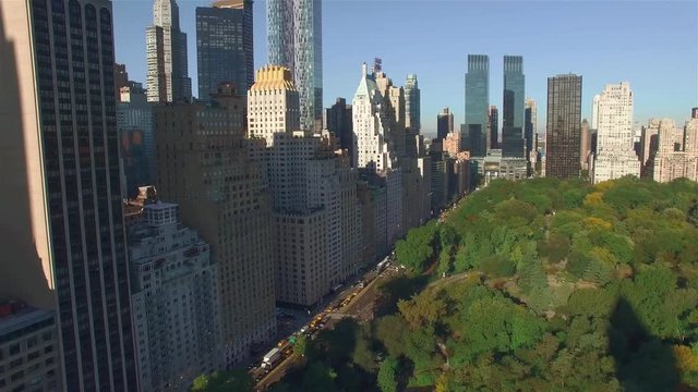 Aerial, camera is flying above Central Park, approaching to the corner of West 95th Street and Fifth Avenue