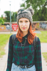 young woman redhead outdoors looking camera smiling - happiness, crefree, customer concept