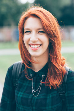 portrait young woman redhead outdoors looking camera smiling - happiness, crefree, customer concept