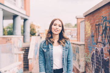 Fototapeta premium portrait of young woman outdoor looking camera smiling - happiness, serene, customer concept
