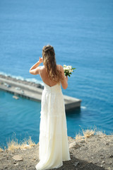 Fototapeta na wymiar Pretty girl or beautiful bride on blue sea