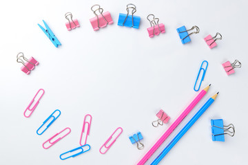 Stationary concept, Flat Lay top view Photo of Scissors, pencils, paper clips, sticky note,stapler in pink and blue tone on white background with copy space