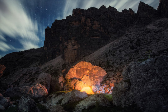 Illuminated tent in mountains at night, Croda da Lago, Italy