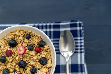 Healthy breakfast granola cereal with blueberries and spoon