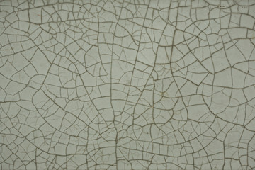Old cracked white tile, black cracks, texture. - obrazy, fototapety, plakaty
