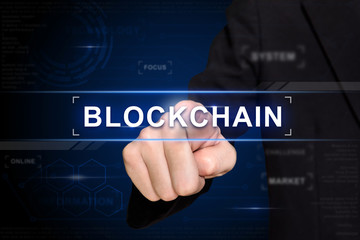 business hand pushing blockchain button on virtual screen