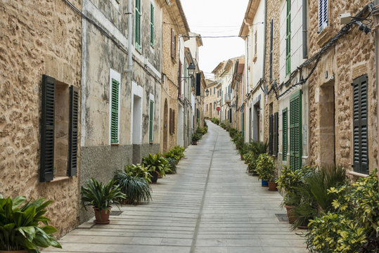 Houses and narrow alley in old town, Alcudia, Spain
