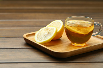 lemon black tea in glass cup on wooden table