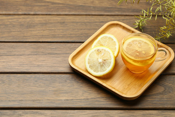 lemon black tea in glass cup on wooden table