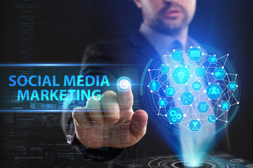 The concept of business, technology, the Internet and the network. A young entrepreneur working on a virtual screen of the future and sees the inscription: Social media marketing