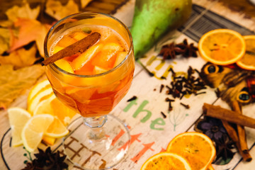 mulled wine with spices on wooden background